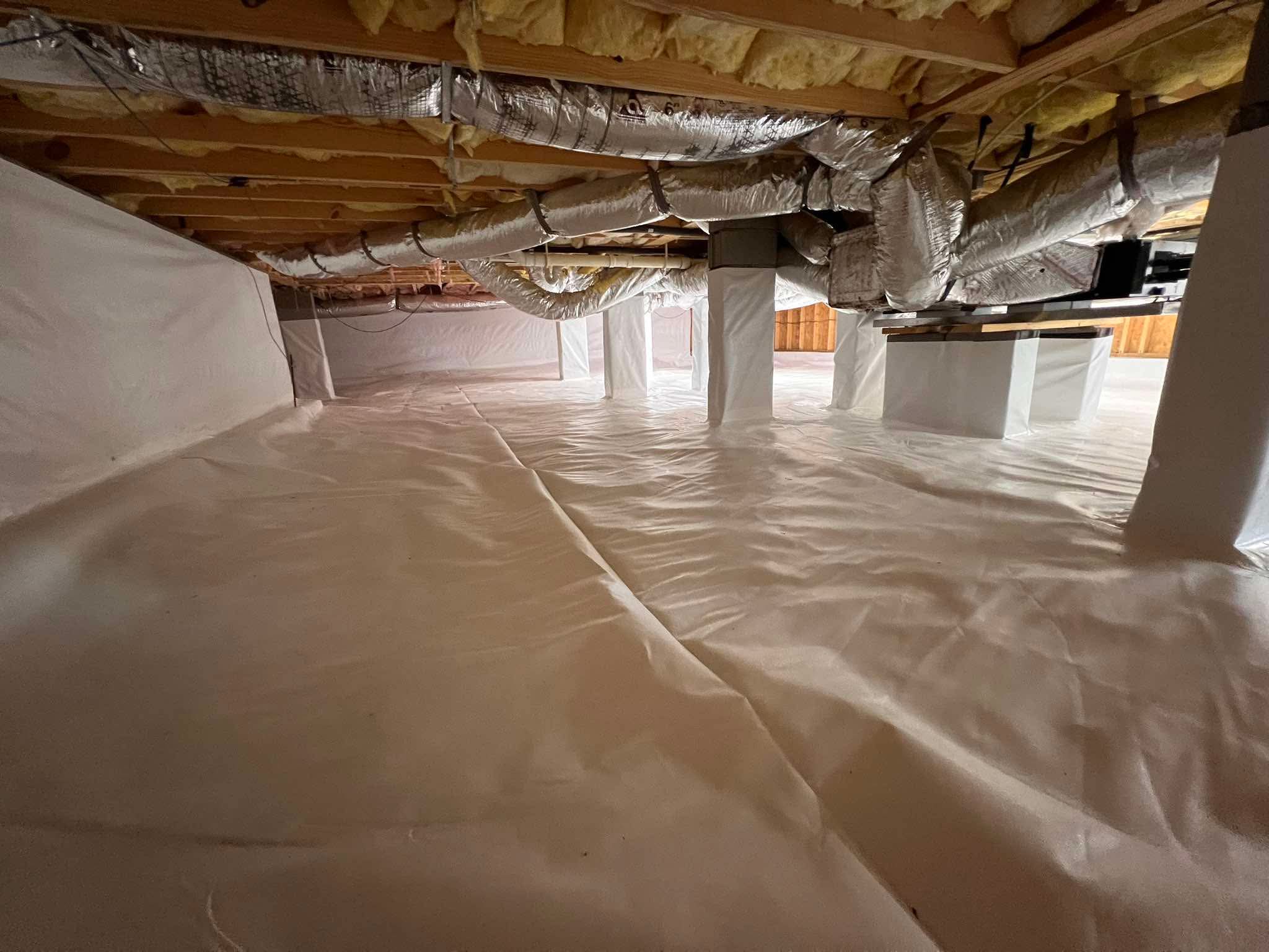 Completed crawl space encapsulation with white vapor barrier